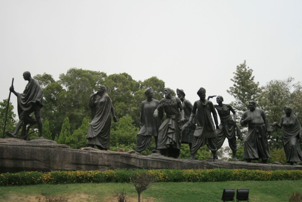 Ultimate Andaman & Nicobar Island Trip Planner Bronze sculptures depicting a famous historical march scene surrounded by greenery.